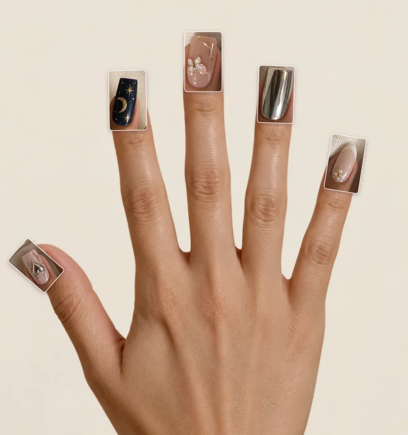 Mano con un diseño distinto en cada uña: luna y estrellas, mariposa, cromado y perlas